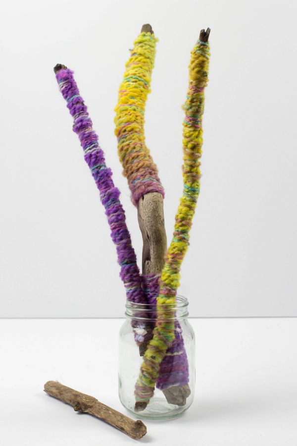 yarn wrapped sticks in jar