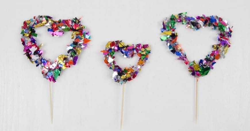 Hot Glue Gun Confetti Heart Cake Topper. This is a fab DIY craft to make a confetti heart, which is perfect as a cake topper for celebrations and if you only confetti one side they make a brilliant window cling. You could make any shape, letter, or number. You could even frame it as art instead of putting a toothpick in it as a cake topper