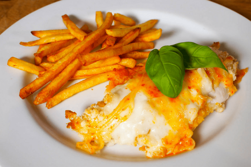 it consists of chicken in breadcrumbs topped with a white béchamel/Parmesan sauce and cheese