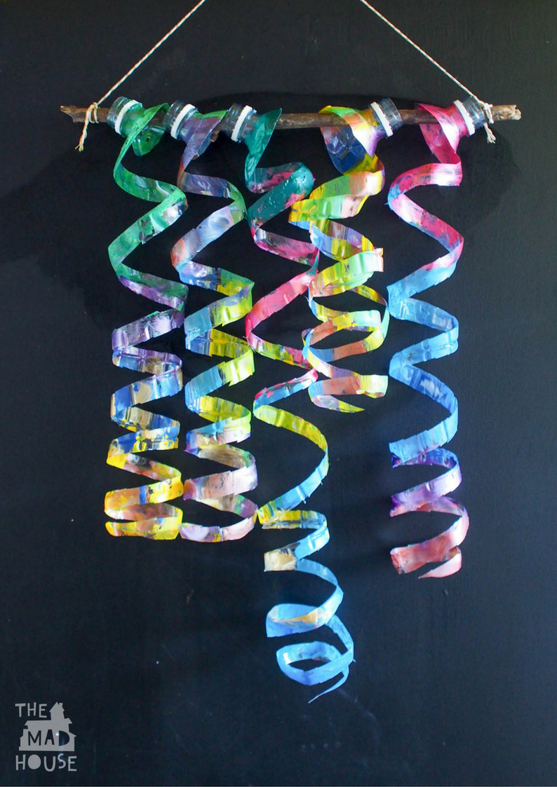Upcycle plastic water bottles with this fantastic child-led process art activity to create a plastic bottle wind spiral mobile and plastic bottle sculpture.
