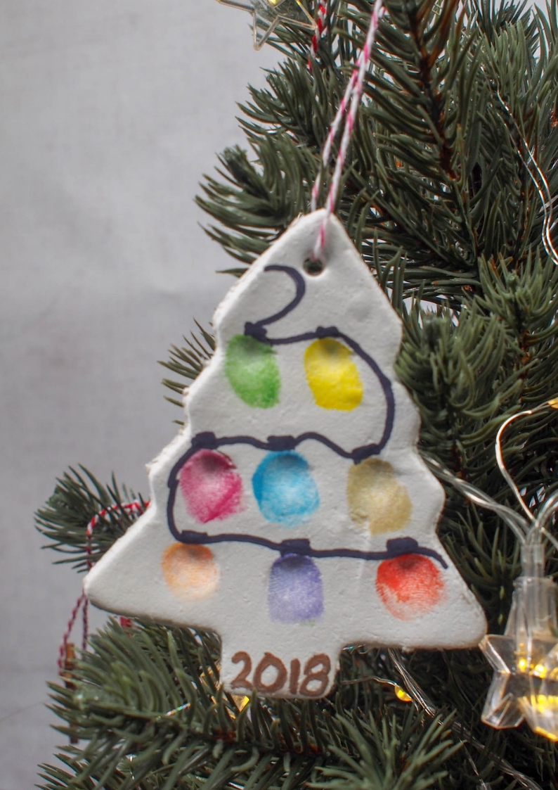 Make a air drying clay christmas tree fingerprint ornament with your family. Your family's fingerprints will look a string of lights on your special keepsake Christmas tree ornament!