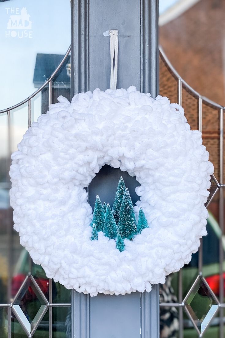 This Simple Winter Wool Forest Wreath is a great DIY Christmas Wreath using loop yarn that will add festive cheer to your front door.