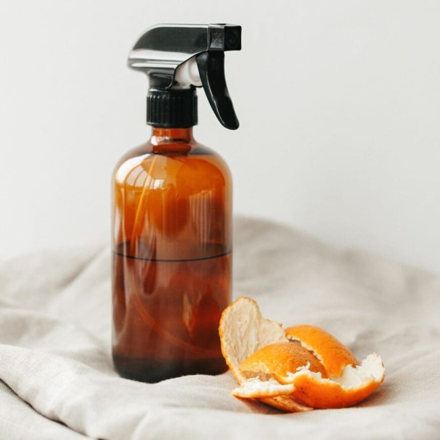 A brown Spray bottle containing citrus infused vinegar 