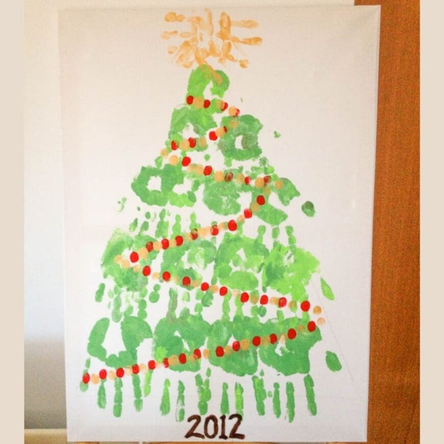 This Handprint Christmas Tree is a fun Christmas craft! Kids of all ages can help make this handprint Christmas tree and put it on display for Christmas!